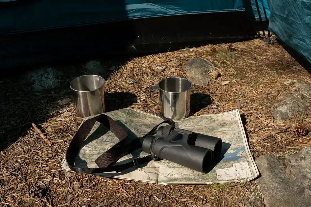 Premium binoculars resting on a field guide